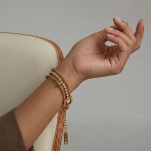 layered gold chain bracelet with crystal strand